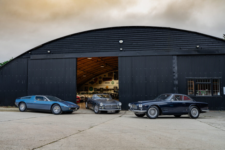 three Maseratis outside the black hanger