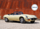 Cream Jaguar E-Type with sold badge